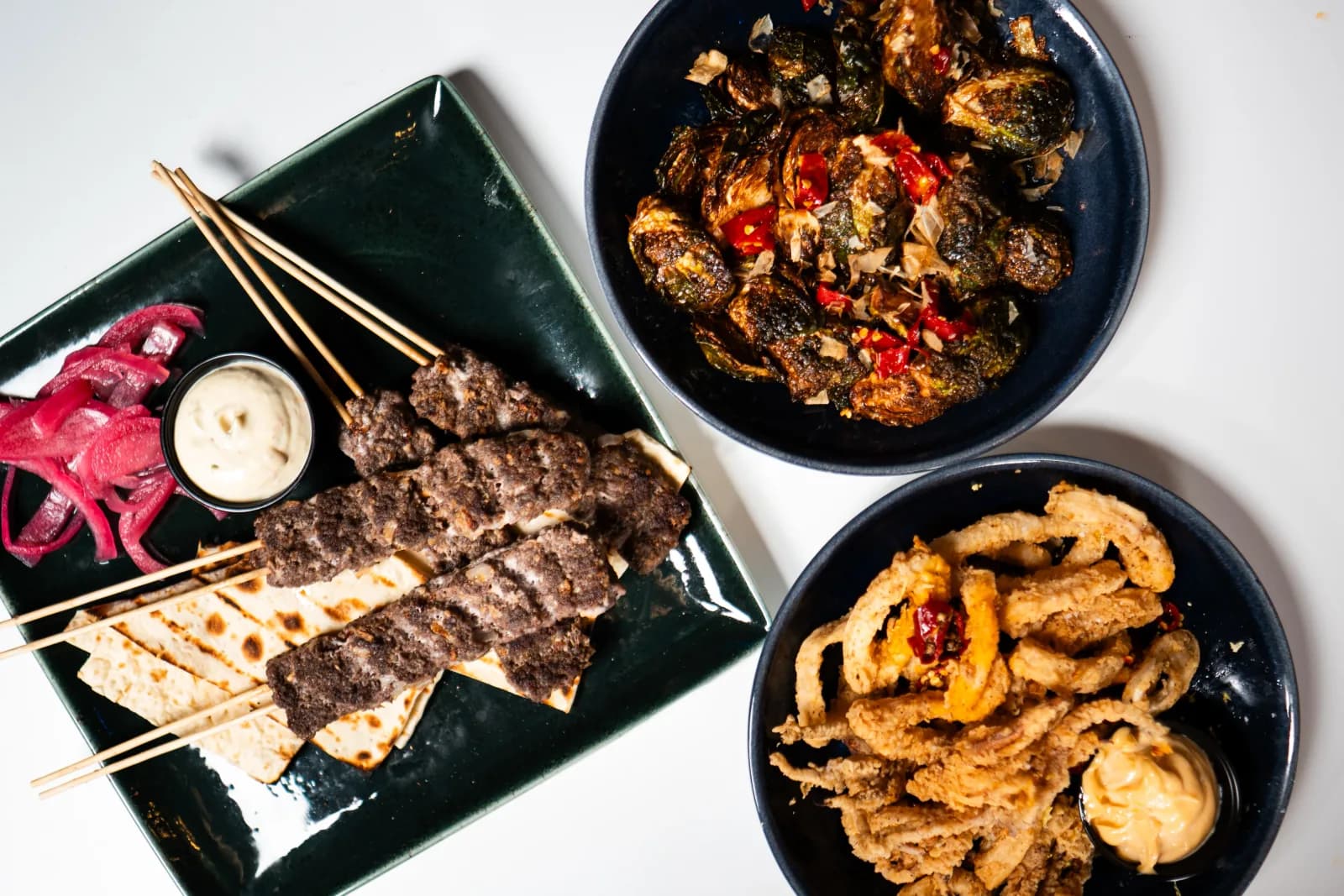 Food, cocktails, and shareables arranged for a Showdown table