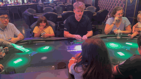 A family gathered around a Showdown Social game table in Alpharetta