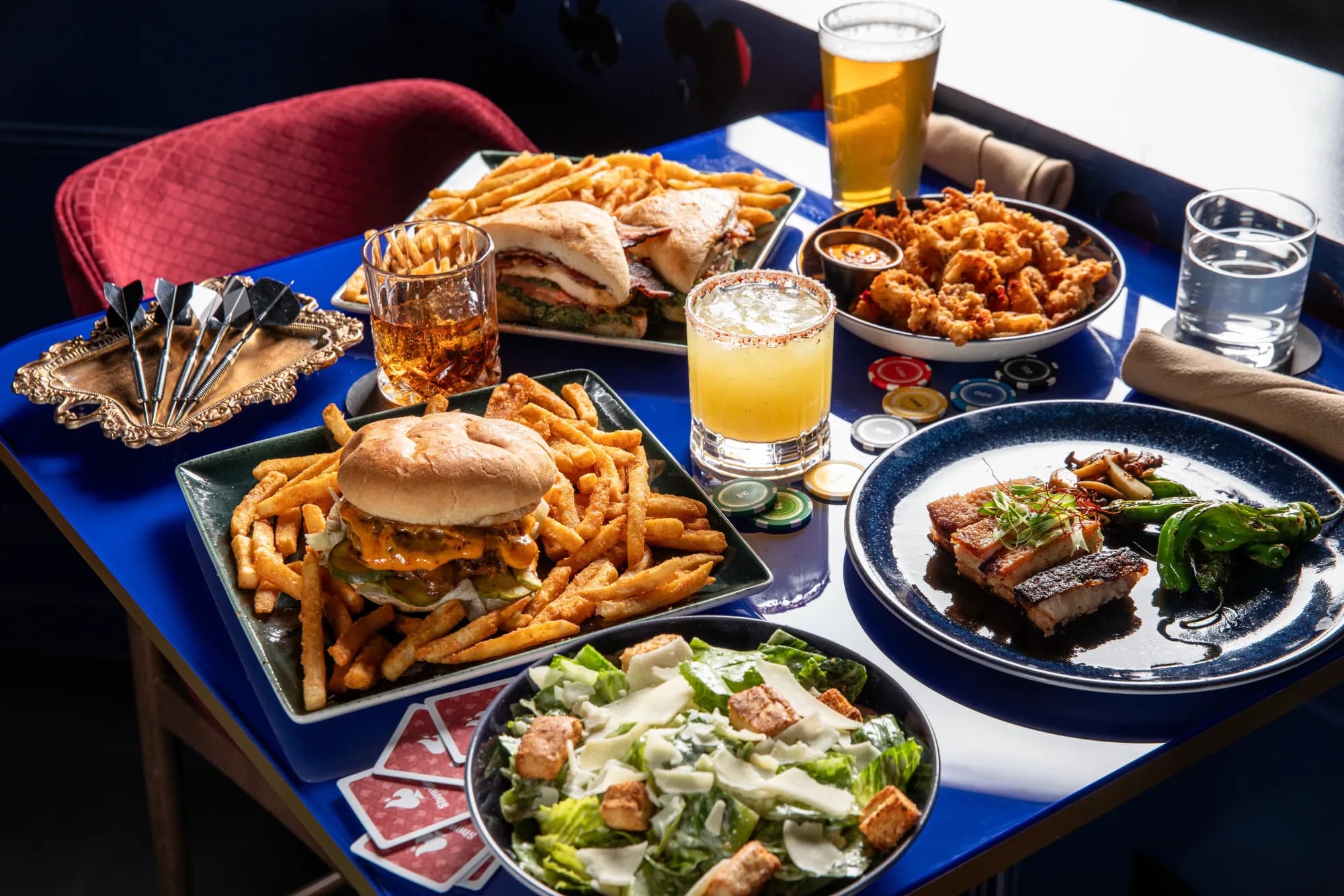 Food and drinks arranged around a Showdown Social game table