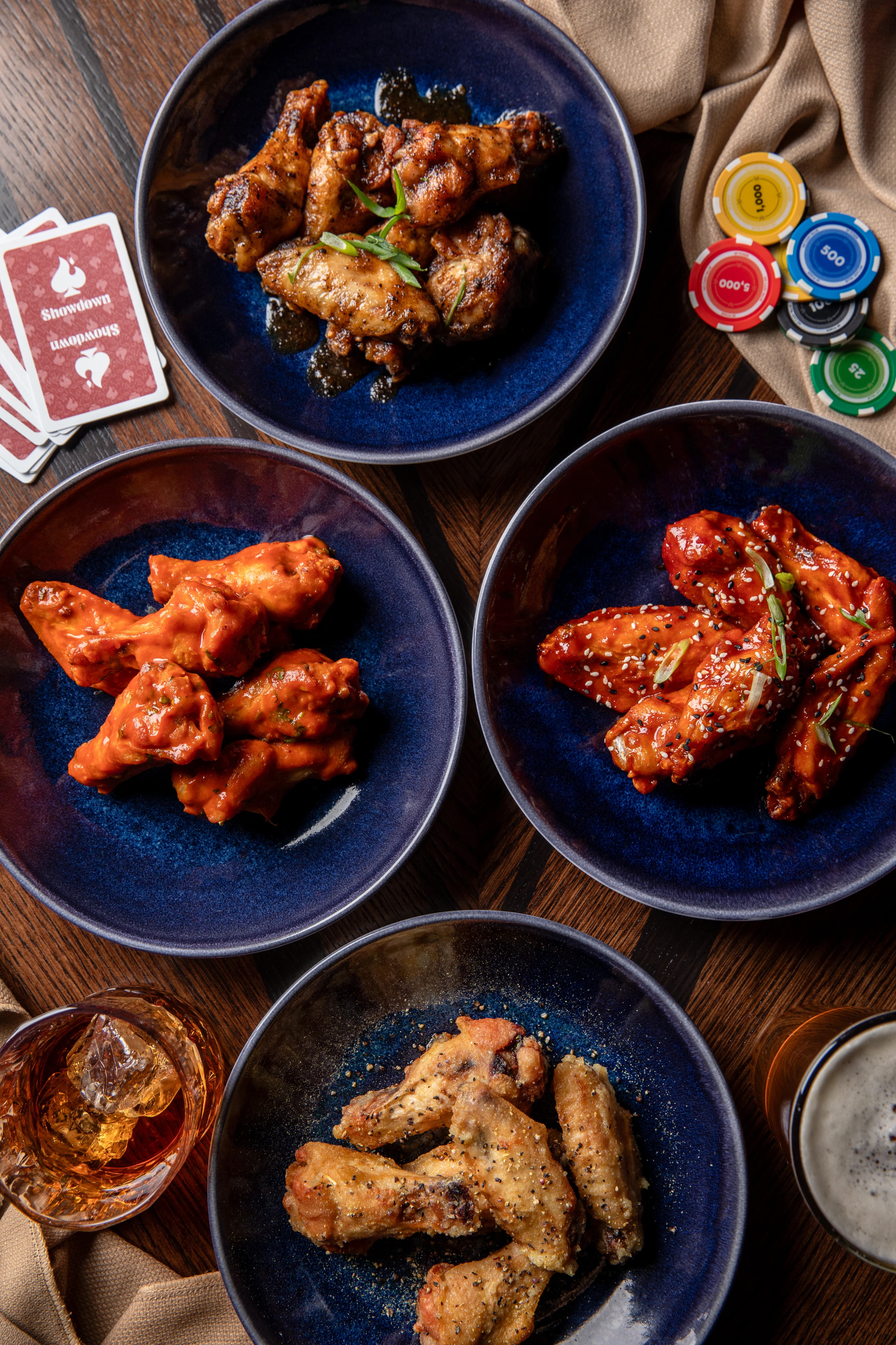 A spread of wings and shareables on a table at Showdown Social
