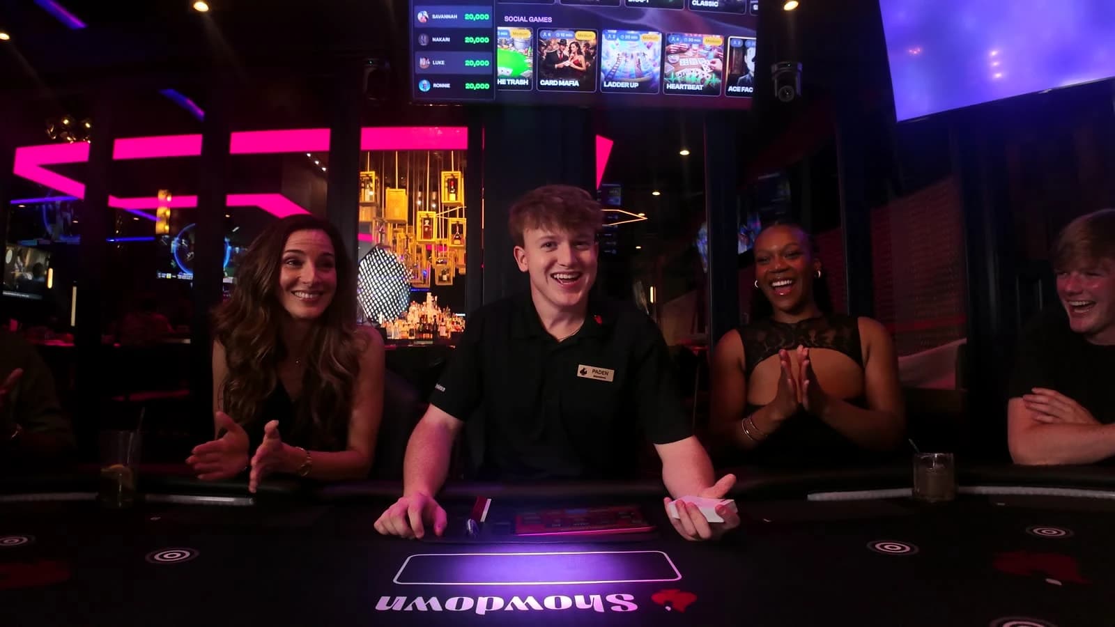 A Showdown Game Host guiding laughing guests at the table