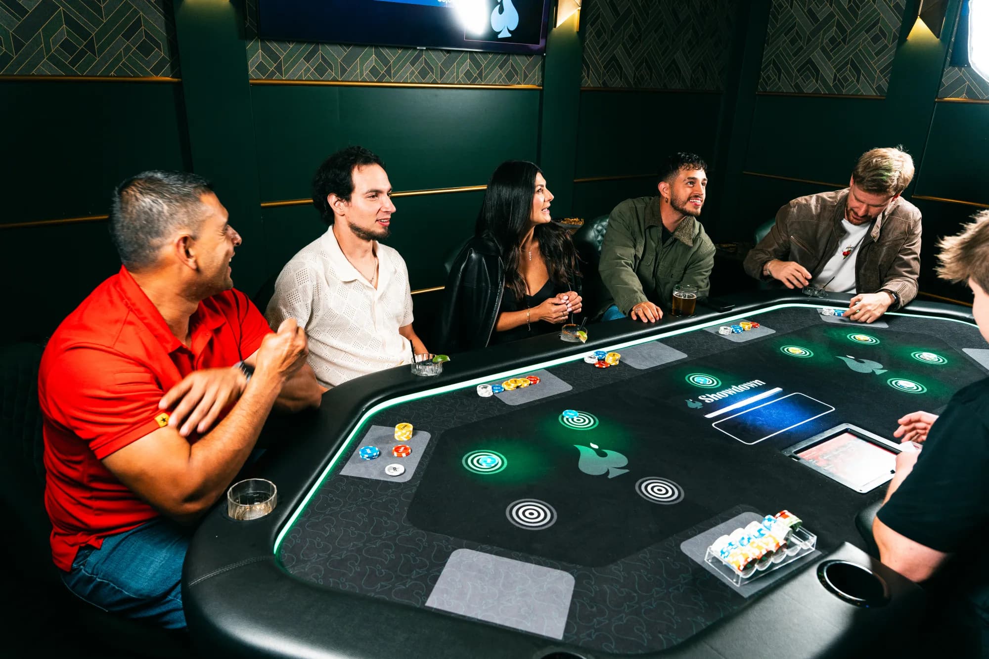 Guests inside Showdown Social surrounded by games, lights, food, and drinks