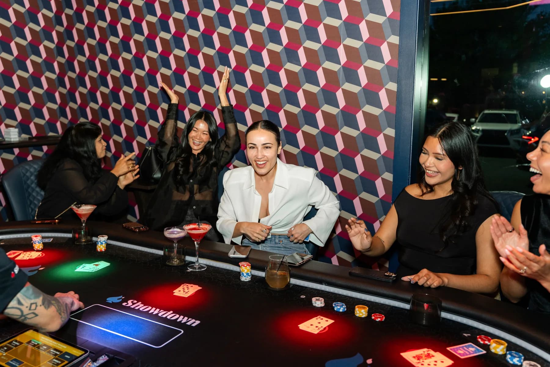 Guests laughing and playing together at a Showdown Social table
