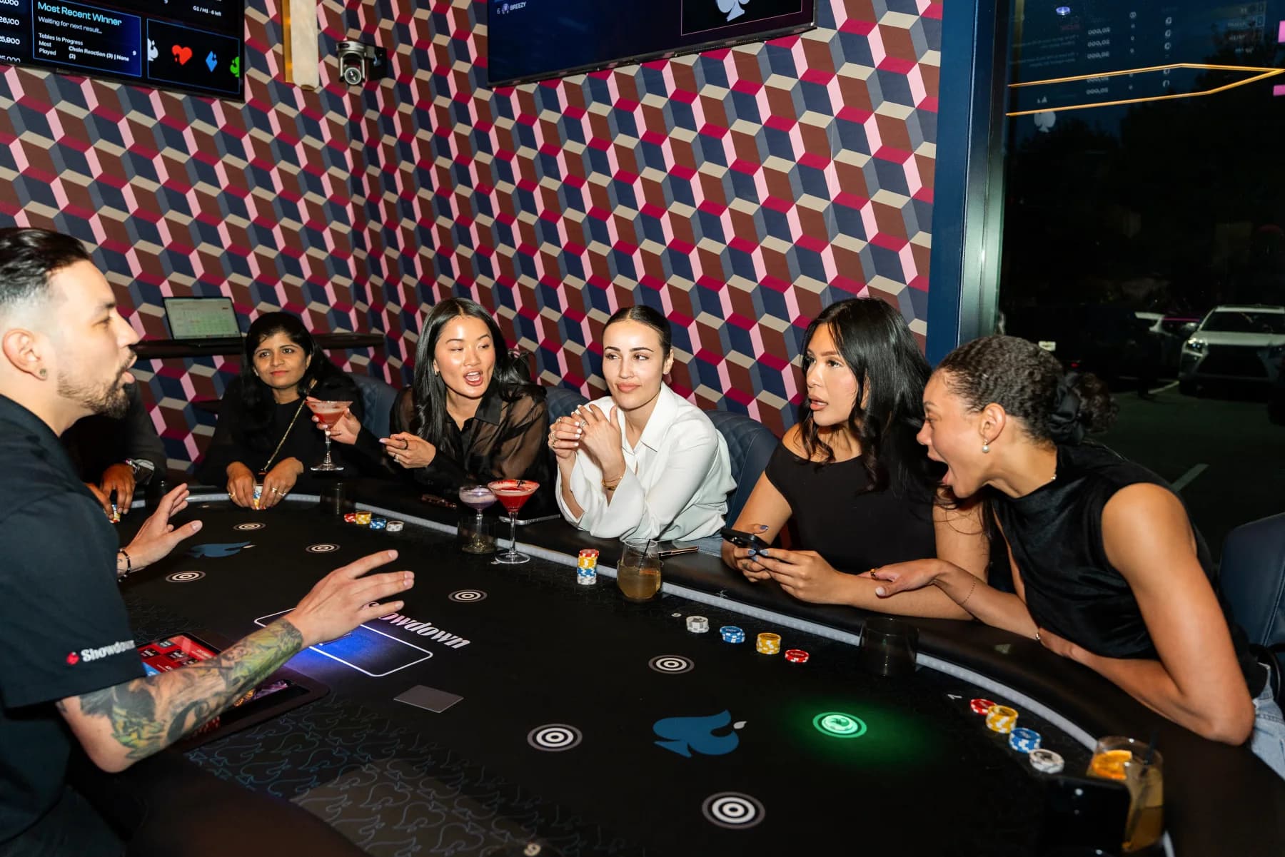 A Game Host leading guests around a Showdown Social game table